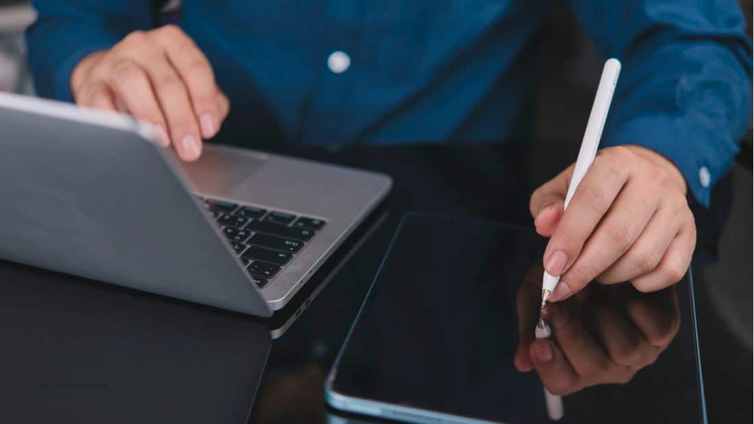 digitale Antragstellung (c) Canva, Khunkorn Person arbeitet am Laptop und Tablet